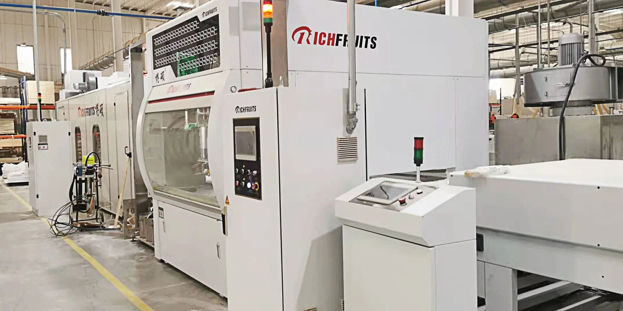 Automatic spray painting machine installed at a customer production site